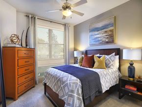 Frisco apartment for rent - a bedroom with a bed and a ceiling fan