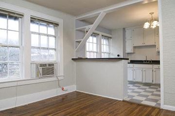 Birmingham apartment for rent - A kitchen with white cabinets and a black and white checkered floor.