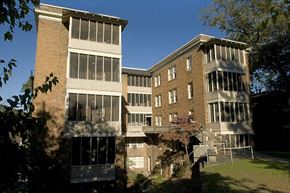 Birmingham apartment for rent - A large building with a lot of windows and a tree in front.