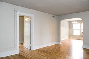 Birmingham apartment for rent - A room with a wooden floor and white walls.