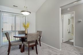 Clinton Township apartment for rent - a dining room with a table and chairs and a large window