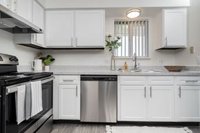 Clinton Township apartment for rent - a white kitchen with stainless steel appliances and white cabinets
