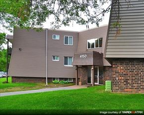 Shoreview apartment for rent - a building with a yard and grass in front of it