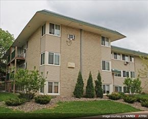 St. Paul apartment for rent - a large brick apartment building with a green yard