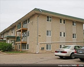 St. Paul apartment for rent - a brick apartment building with cars parked in a parking lot