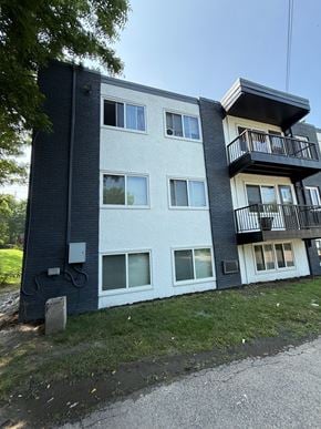 Columbia apartment for rent - A modern two-story apartment building with a balcony on the upper floor.
