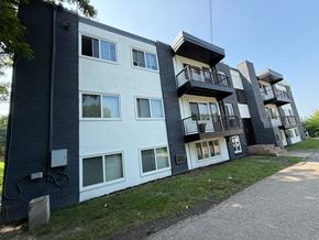 Columbia apartment for rent - A modern apartment building with balconies and a mix of white and dark exterior walls.
