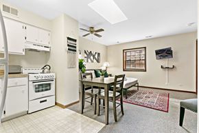 Highland Park apartment for rent - a kitchen with a dining table and a stove and a ceiling fan