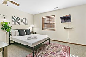 Highland Park apartment for rent - a bedroom with a bed and a rug and a window