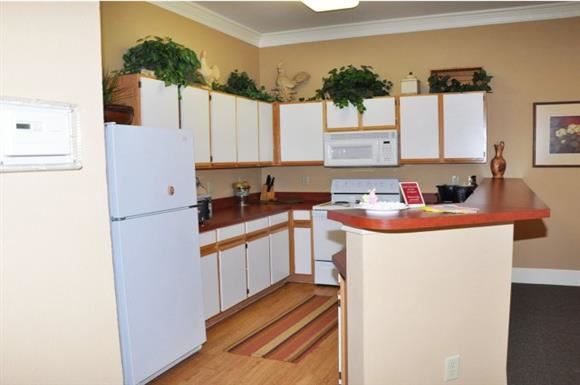 Weatherford apartment for rent - A kitchen with a white refrigerator and wooden floors.