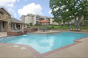 Weatherford apartment for rent - A swimming pool surrounded by a brick border.