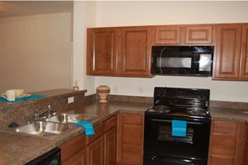 Weatherford apartment for rent - A black oven with a blue towel on it.