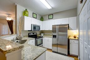 Gainesville apartment for rent - a kitchen with stainless steel appliances and granite counter tops