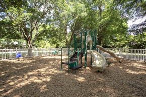 Gainesville apartment for rent - a playground with a slide and other toys in a park