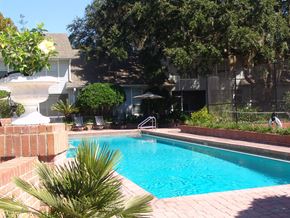 Gainesville townhouse for rent - a large swimming pool in front of a house