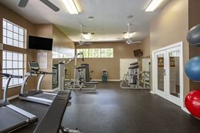 Gainesville townhouse for rent - a gym with treadmills and other exercise equipment and a window