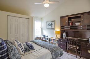 Gainesville townhouse for rent - a bedroom with a bed and a desk and a closet
