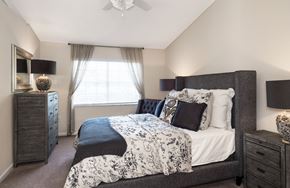 Gainesville apartment for rent - a bedroom with a bed and a dresser and a window