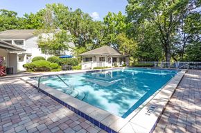 Gainesville townhouse for rent - a swimming pool with a house in the background