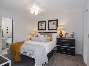 Gainesville townhouse for rent - a bedroom with a bed and a ceiling fan