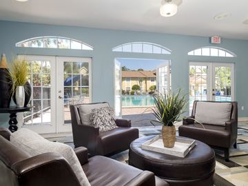 Winter Park apartment for rent - a living room with couches and chairs and a pool