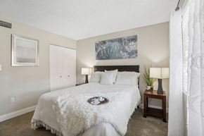 Winter Park apartment for rent - A bedroom with a large bed and a painting on the wall.