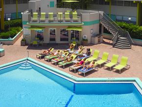 Gainesville townhouse for rent - a swimming pool with lounge chairs and a poolside hotel