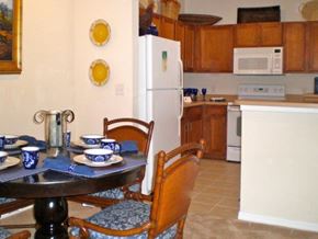 Orlando apartment for rent - a kitchen with a table and chairs and a refrigerator