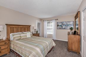 Lakeland apartment for rent - a bedroom with a bed and a dresser and a window