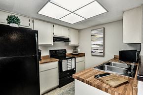 Gainesville townhouse for rent - a kitchen with a sink and a refrigerator