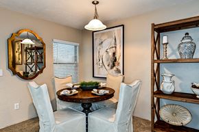 Gainesville townhouse for rent - a dining room with a table and chairs and a mirror