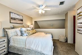 Gainesville townhouse for rent - a bedroom with a bed and a ceiling fan