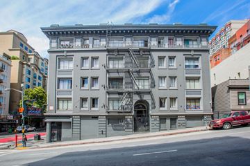 San Francisco apartment for rent - A large grey building with a fire escape on the front.