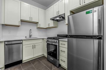 San Francisco apartment for rent - A kitchen with white cabinets and a stainless steel refrigerator.