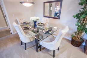 Vacaville apartment for rent - a dining room with a glass table and white chairs