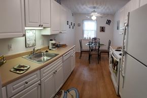 Ypsilanti apartment for rent - a kitchen and dining room with white cabinets