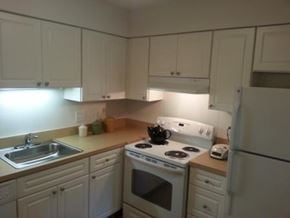 Detroit apartment for rent - A kitchen with white appliances and cabinets.