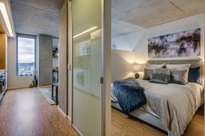 Seattle apartment for rent - a bedroom with a large bed and a mirrored closet