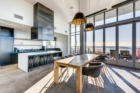 Seattle apartment for rent - a dining area with a wooden table and chairs and a kitchen with large windows
