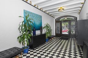 San Francisco apartment for rent - A black and white checkered floor in a room with a blue plant and a blue pot.