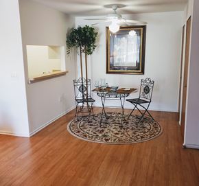 Detroit apartment for rent - a dining room with a table and chairs and a mirror on the wall
