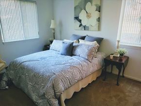 Detroit apartment for rent - a bedroom with a bed and a side table