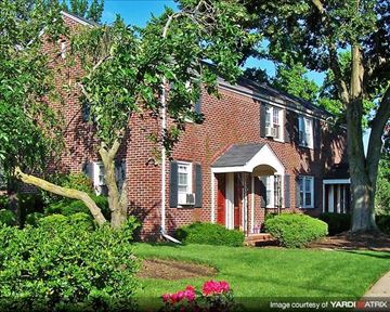 Caldwell apartment for rent - A red brick house with a white door and windows.