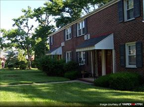 Caldwell apartment for rent - A red brick house with a white awning and black shutters.