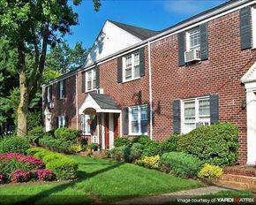 Caldwell apartment for rent - A red brick house with white trim and a green lawn.