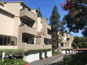 San Diego apartment for rent - Apartment building with a red roof and white garage doors.