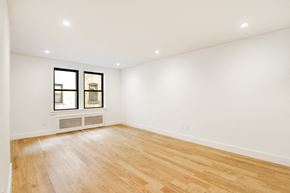 Brooklyn apartment for rent - a living room with white walls and wood floors and a window