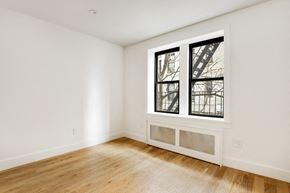 Brooklyn apartment for rent - a living room with wood floors and a large window