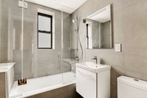 Brooklyn apartment for rent - a bathroom with a shower and a sink and a mirror