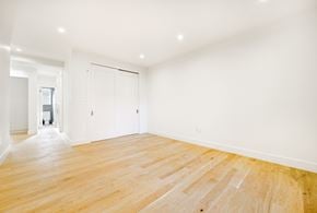 Brooklyn apartment for rent - A room with a wooden floor and white walls.
